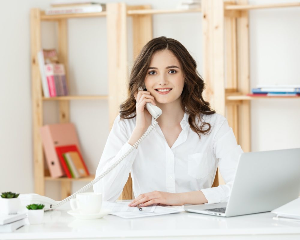 young-woman-talking-on-phone-in-modern-office.jpg